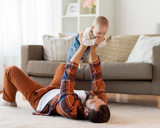 A father enjoying newly installed underfloor heating with his son